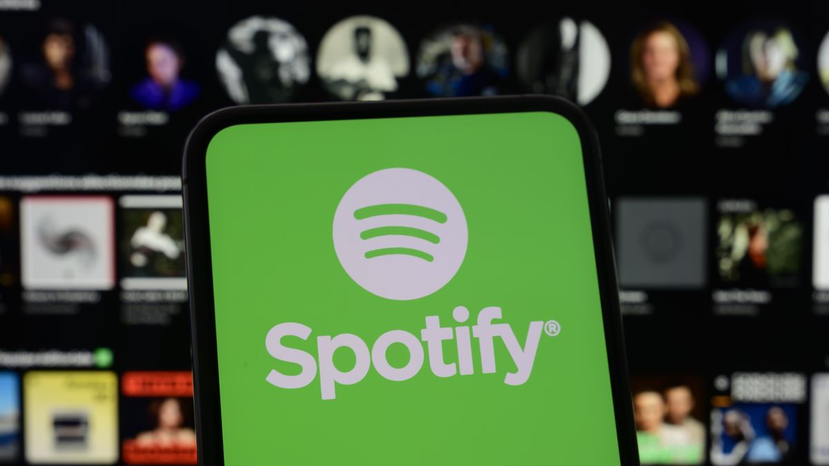 The Spotify logo is displayed on a smartphone screen with the streaming service's homepage in the background, in Creteil, France, on May 22, 2026. The music streaming leader announces a partnership with Universal Music Group, allowing its users to legally create AI-powered remixes from catalogs of major artists. (Photo by Samuel Boivin/NurPhoto via Getty Images)
