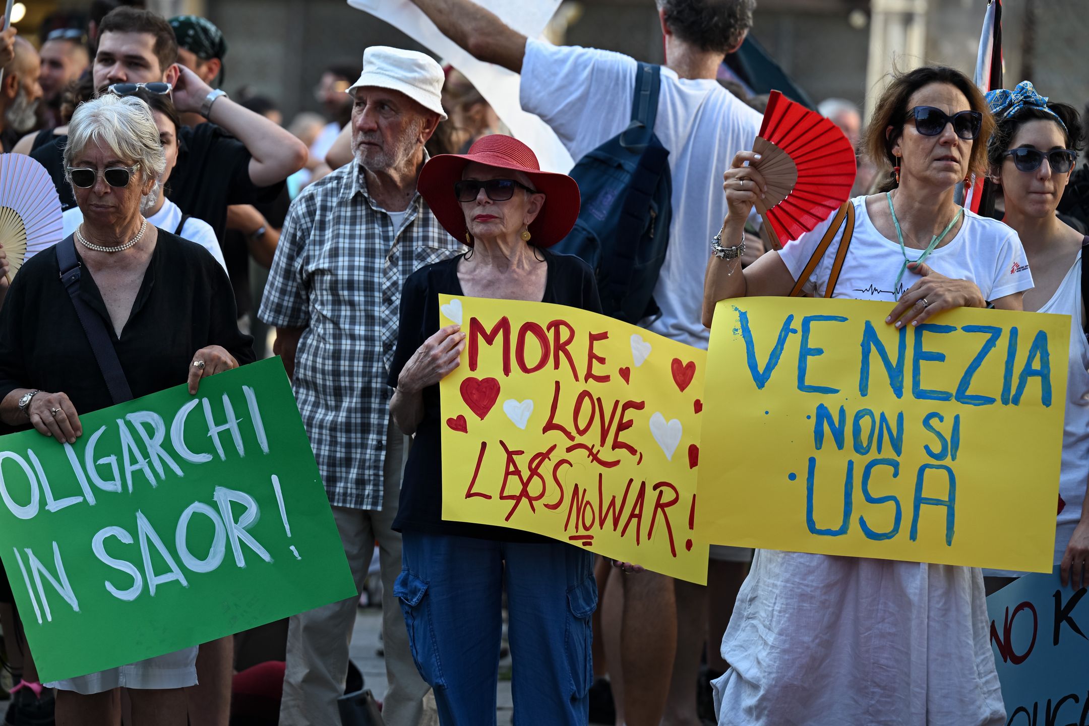 VENICE, ITALY - JULY 17: Demonstrators hold placards to protest against the visit of US Ambassador to Italy Tilman Fertitta, who arrived aboard his 117-metre megayacht, in Venice, Italy, on July 17, 2026. According to organisers, the protest opposed Fertitta's visit during the city's annual Redentore festival and criticized mass tourism, the influence of billionaires on Venice, and US policies under President Donald Trump. (Photo by Piero Cruciatti/Anadolu via Getty Images)