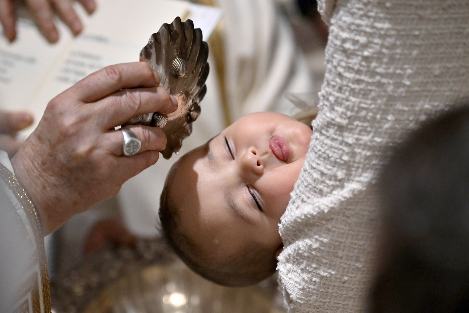 VATICAN CITY, VATICAN - JANUARY 07: (EDITOR NOTE: STRICTLY EDITORIAL USE ONLY - NO MERCHANDISING) Pope Francis baptises 16 infants in the Sistine Chapel on January 07, 2024 in Vatican City, Vatican. As is customary on the Feast of the Baptism of the Lord, Pope Francis baptised 16 infants in the Sistine Chapel, welcoming them into their new life of faith. (Photo by Vatican Media via Vatican Pool/Getty Images)
