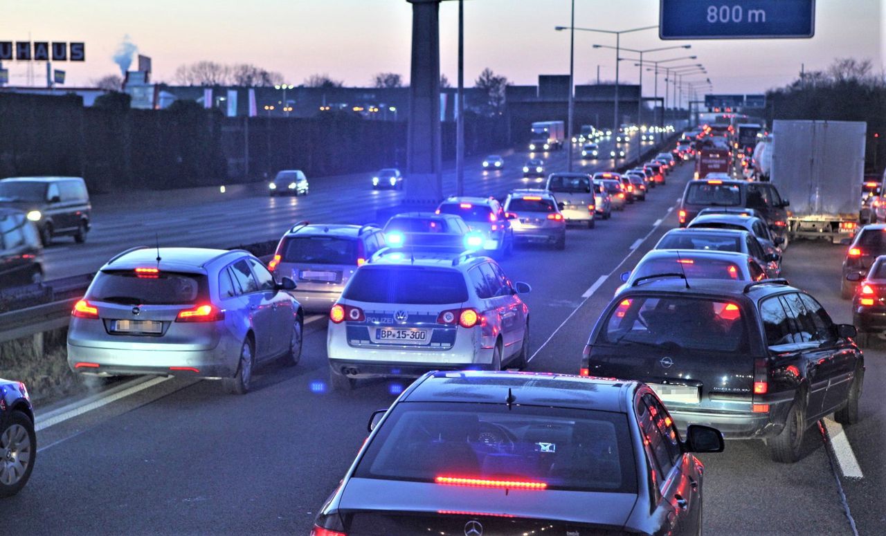 Children play soccer on a German highway amid traffic chaos