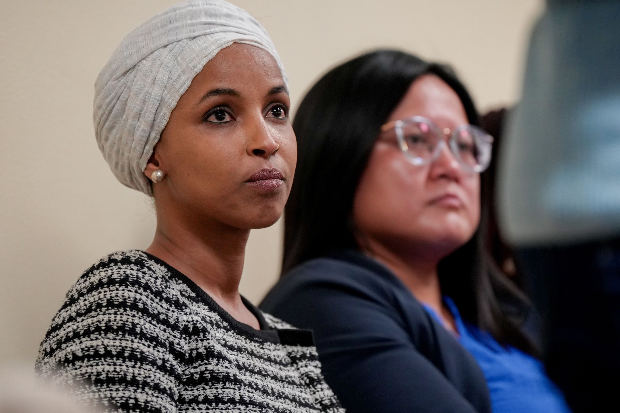 Representative Ilhan Omar, a Democrat from Minnesota, left, during a town hall event in Minneapolis, Minnesota, US, on Tuesday, Jan. 27, 2026. A man was apprehended during a town hall event with Democratic Representative Ilhan Omar after spraying unknown substance, according the to Associated Press. Photographer: Angelina Katsanis/Bloomberg via Getty Images