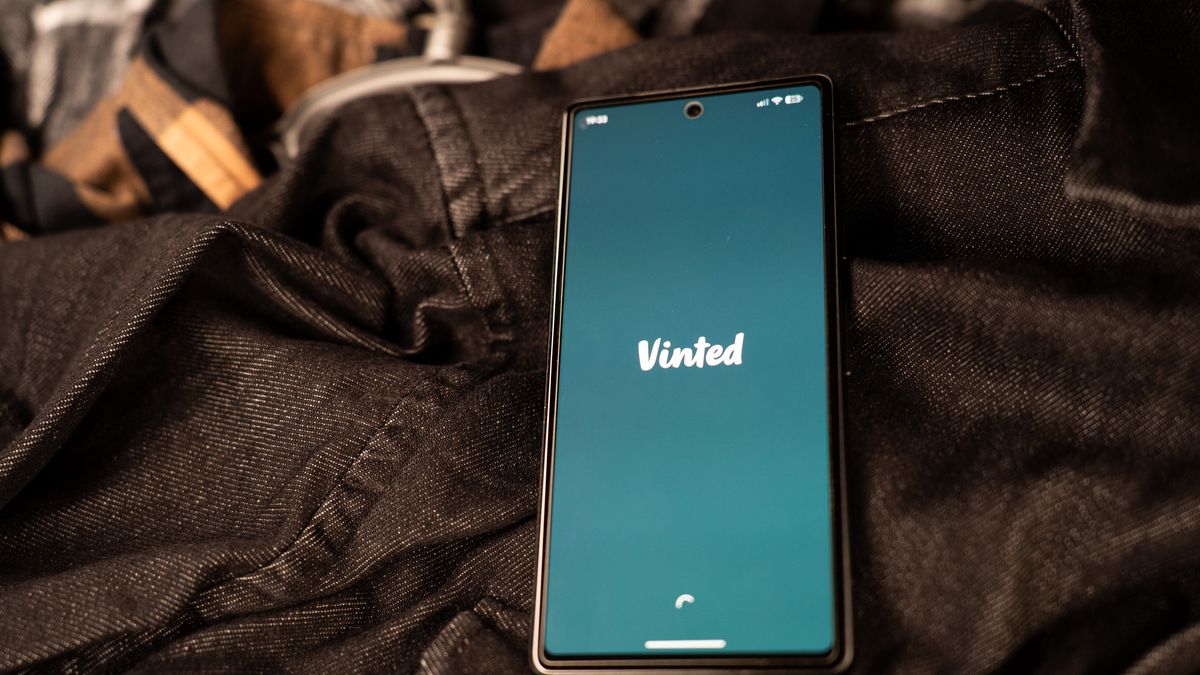 The Vinted logo appears on a smartphone screen as the phone rests among second-hand clothing in this illustration photo in Athens, Greece, on February 15, 2026. (Photo by Nikos Pekiaridis/NurPhoto via Getty Images)