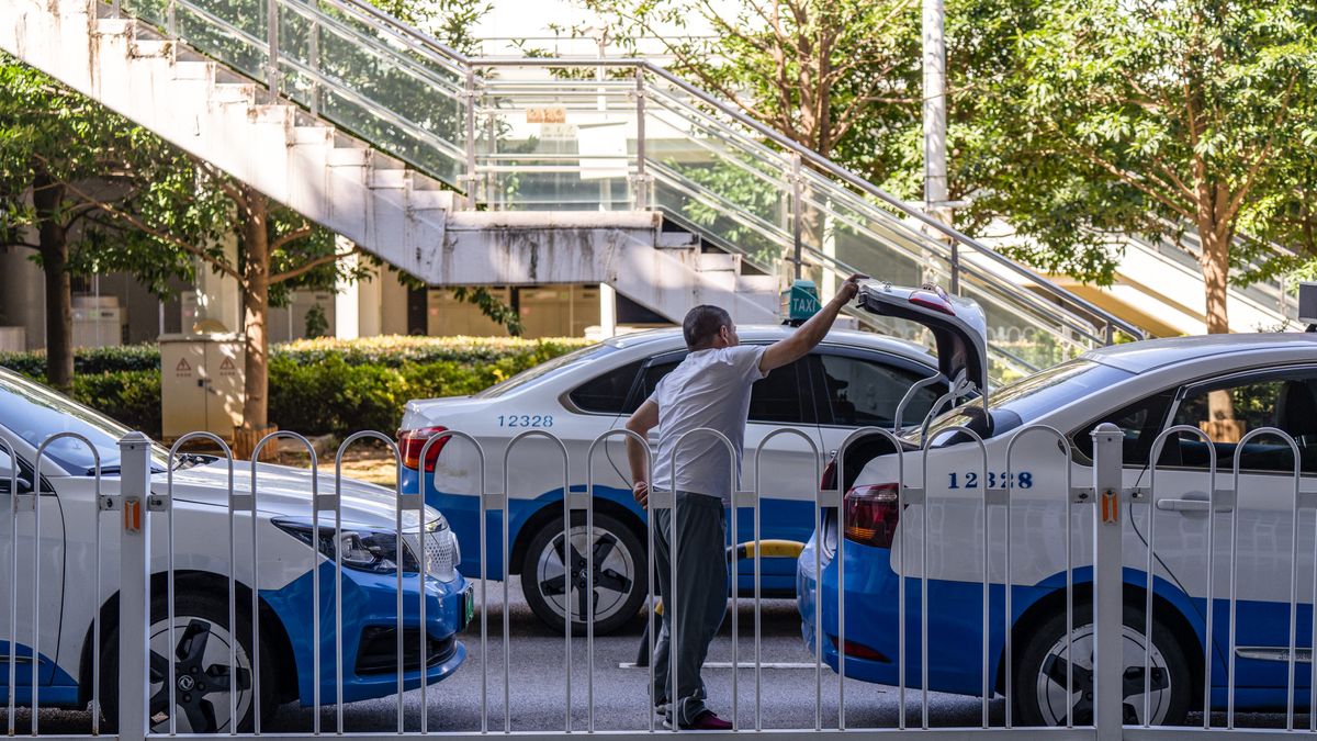 Taxis wait for fares outside the airport in Wuhan, China, on Sunday, July 21, 2024. More than 500 electric robotaxis built by Baidu Inc. currently ply the city's streets, with plans for an additional 1,000 to be deployed by year-end. Photographer: Qilai Shen/Bloomberg via Getty Images
