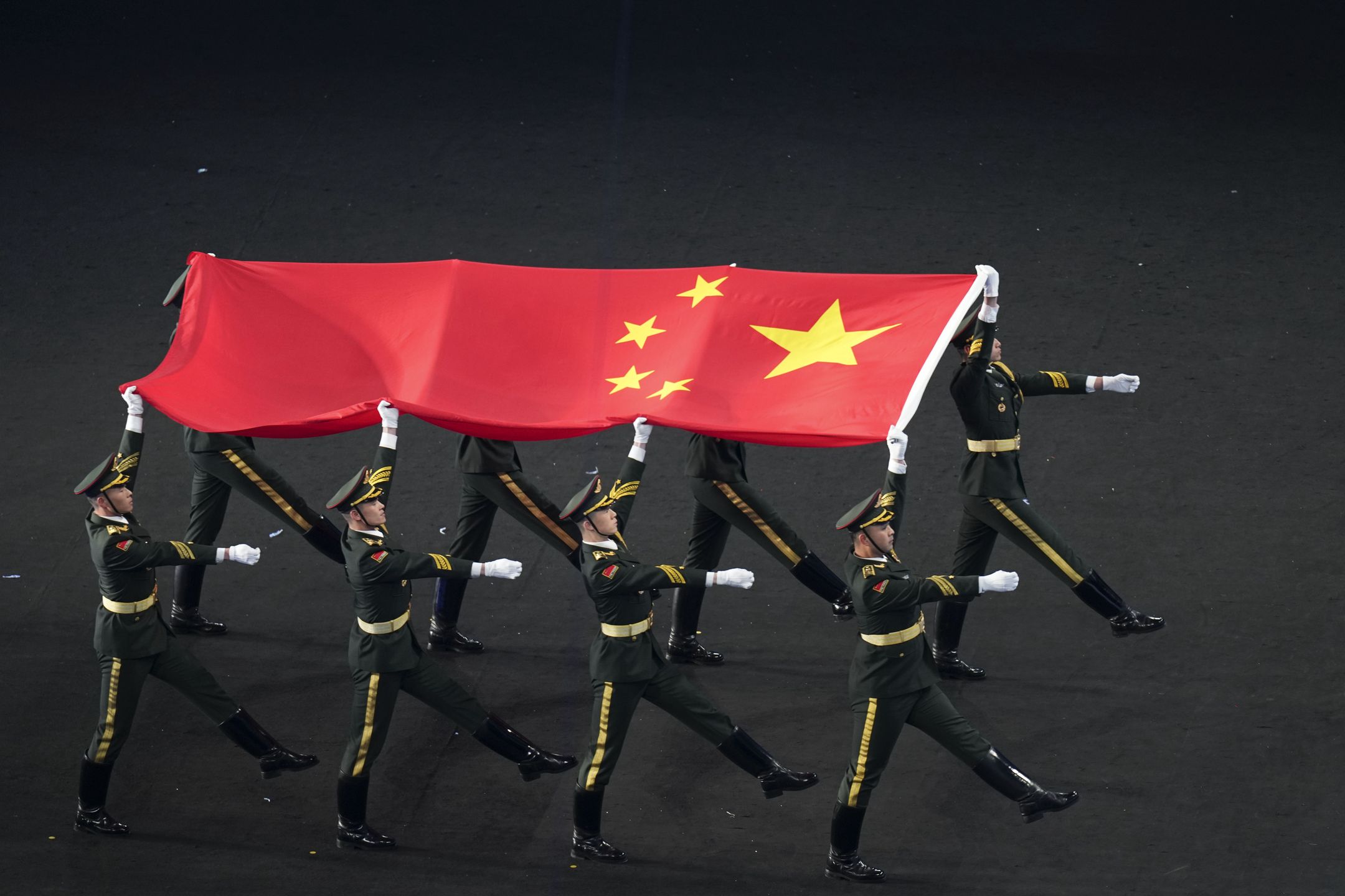 BEIJING, CHINA - FEBRUARY 04: A Chinese national flag is carried during the Opening Ceremony of the Beijing 2022 Winter Olympics at the Beijing National Stadium on February 4, 2022 in Beijing, China. (Photo by Cui Nan/China News Service via Getty Images)