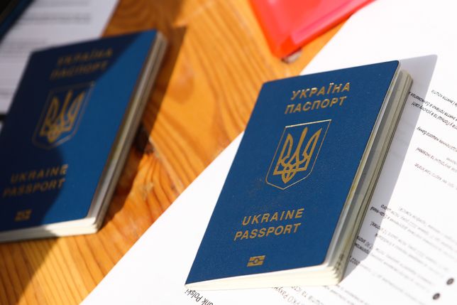 Ukrainian passports are seen on a table outside the sports hall where registration point for National Identification Number is opened, in Krakow, Poland on March 16, 2022. Tens of thousends Ukrainian refugees come to Poland due Russian invasion and from March 16 they can register in the Polish national PESEL identification number system. (Photo by Jakub Porzycki/NurPhoto via Getty Images)