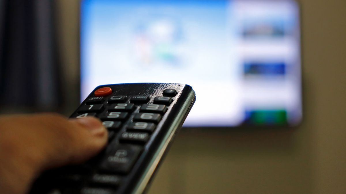 Hand holding remote control of television. Man watching TV at home and using remote control.
Hand holding remote control of television. Man watching TV at home and using remote control.
Rapeepong Puttakumwong