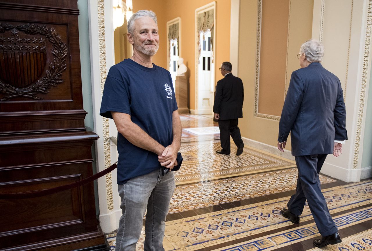 UNITED STATES - JULY 23: Jon Stewart, former host of The Daily Show, smiles as Senate Majority Leader Mitch McConnell, R-Ky., walks by at the Ohio Clock Corridor in the Capitol on Tuesday, July 23, 2019. The Senate will be voting later today on HR 1327: Never Forget the Heroes: Permanent Authorization of the September 11th Victim Compensation Fund Act. (Photo By Bill Clark/CQ Roll Call)