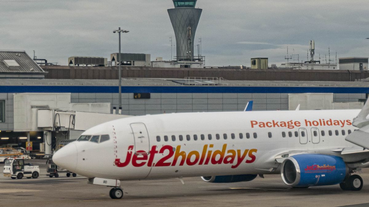 Jet2 Boeing 737-800 aircraft as seen in Edinburgh Airport in front of the terminal and the control tower. The Jet2.com Boeing 737 passenger airplane has the registration G-JZBD, has the inscription Jet2holidays logo and is powered by 2 CFMI jet engines. Jet2 is a low cost leisure airline with scheduled and charter airlines from the United Kingdom. Edinburgh, Scotland, United Kingdom on August 29, 2022 (Photo by Nicolas Economou/NurPhoto via Getty Images)