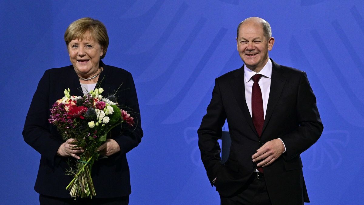 Olaf Scholz zaprzysi??ony na kanclerza NiemiecGerman Chancellor Olaf Scholz and his predecessor Angela Merkel pose after Scholz gave Merkel a bouquet of flowers during a handover ceremony at the Chancellery in Berlin on December 8, 2021. - Members of the parliament elected Olaf Scholz as the country's next Chancellor, ushering in a new political era with the centre-left in charge. Together with the Greens and the liberal Free Democrats, Scholz's SPD managed in a far shorter time than expected to forge a coalition that aspires to make Germany greener and fairer. (Photo by John MACDOUGALL / AFP)JOHN MACDOUGALL