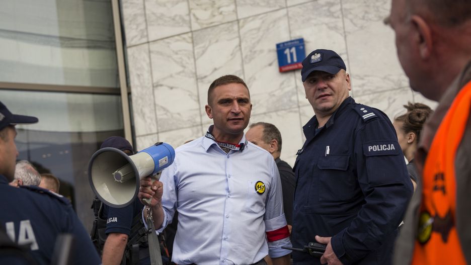 WARSAW, MAZOWIECKIE, POLAND - 2019/08/01: Robert Bakiewicz - the leader of the National Radical Camp (ONR) talks to a policeman during the march.Thousands of people took part in a march organised by the National Radical Camp (ONR) and other nationalist organizations to celebrate the 75th anniversary of the Warsaw Uprising.  At the monument of the Insurgents of Warsaw, the March was blocked by the Antifascist and Citizens of the Republic of Poland (Obywatele RP), who were forcefully removed by the police. The Warsaw Uprising was the largest military operation by any resistance movement in Europe against the Nazi German occupiers during World War II. (Photo by Attila Husejnow/SOPA Images/LightRocket via Getty Images)