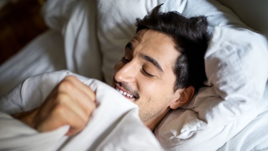 Man sleeping comfortably in bed
Smiling young man sleeping comfortably in bed at home
Luis Alvarez