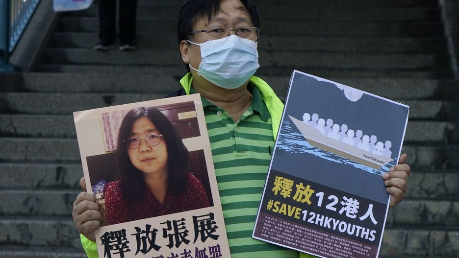 arch43A pro-democracy activist holds placards with the picture of Chinese citizen journalist Zhang Zhan outside the Chinese central government's liaison office, in Hong Kong, Monday, Dec. 28, 2020. Zhang, a former lawyer and citizen journalist from Shanghai, has been sentenced to four years in prison for her reporting on the initial coronavirus outbreak in Wuhan, China. The activists demand the releases of Zhang, as well as the 12 Hong Kong activists detained at sea by Chinese authorities. (AP Photo/Kin Cheung)AP