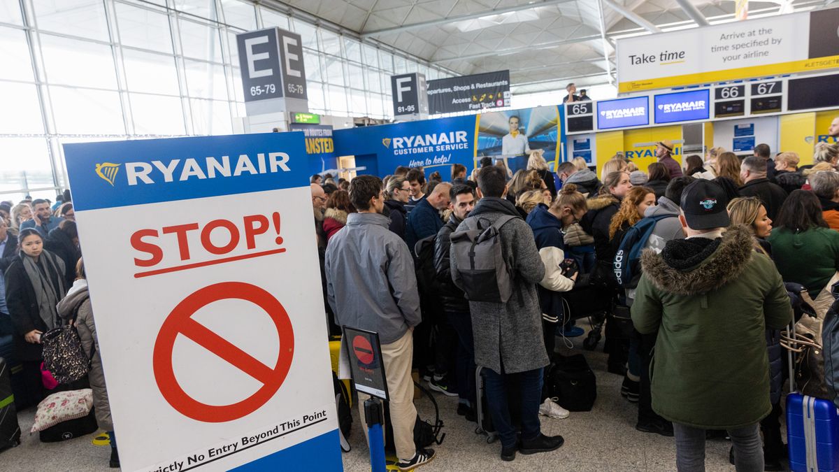 Passengers queue for Ryanair Holdings Plc flights at the check-in area at London Stansted Airport, operated by Manchester Airport Plc, in Stansted, UK, on Monday, Dec. 12, 2022. With London blanketed in snow, the Met Office has yellow weather warnings for snow and ice in place throughout the UK until Thursday. Photographer: Chris Ratcliffe/Bloomberg via Getty Images
