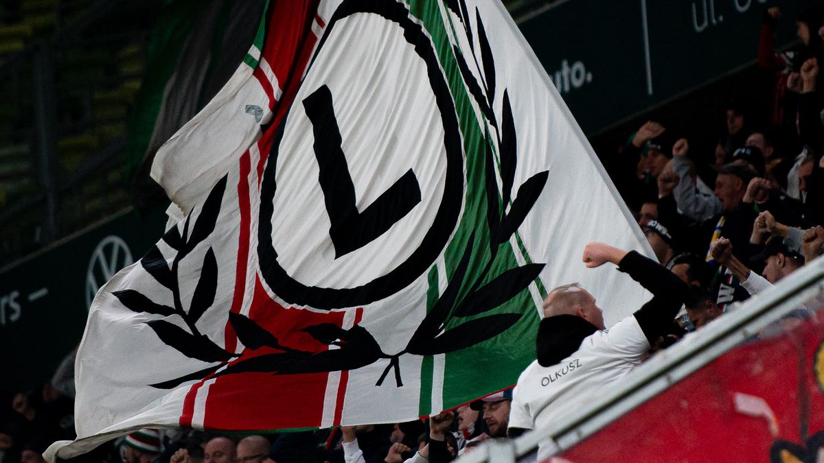 GDANSK, POLAND - OCTOBER 18: Supporters of Legia Warszawa seen with flag on the tribune during PKO Ekstraklasa match between Lechia Gdansk and Legia Warszawa at Polsat Plus Arena on October 18, 2024 in Gdansk, Poland.  (Photo by Mateusz Slodkowski/Getty Images)