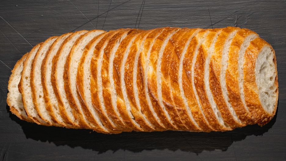 Top view of slices of white bread on wooden chopping board, panoramic shotTop view of slices of white bread on wooden chopping board, panoramic shot.bread, loaf, baguette, food, slice, organic, wheat, meal, baked, horizontal, no people, product, rustic, crust, cut, healthy, italian, fresh, gourmet, table, traditional, wooden, healthy eating, nutrition, crunchy, cutting board, abundance, healthy lifestyle, serving, surface, carbohydrate, homemade, french, piece, rural, breakfast, view, top view, diet, natural, top, sliced bread, slice of food, typical, table top view, loaf of bread