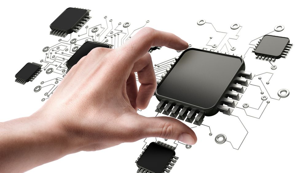 Man's hand holding CPU chip isolated on white background