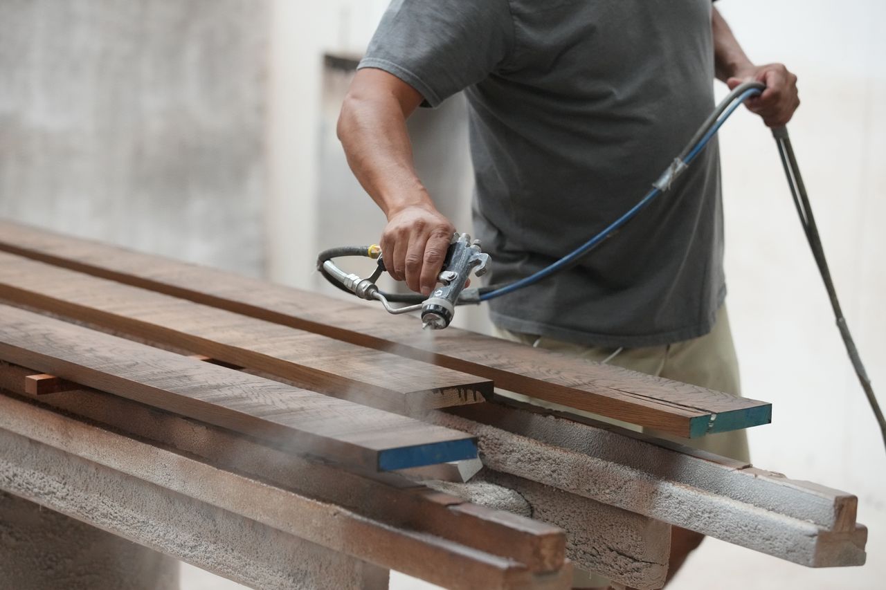 A worker sprays varnish on wood pieces at a JLR Contractors facility in Provo, Utah, US, on Wednesday, Sept. 13, 2023. Markit is scheduled to release manufacturing purchasing managers' index (PMI) figures on September 22. Photographer: George Frey/Bloomberg via Getty Images