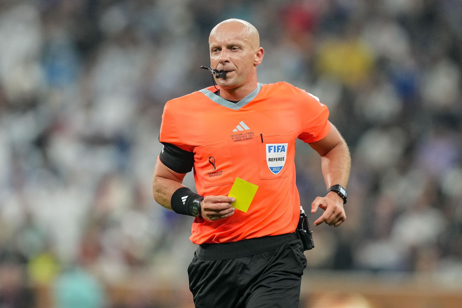 LUSAIL CITY, QATAR - DECEMBER 18: referee Szymon Marciniak of Poland the yellow card for Enzo Fernandez of Argentina during the FIFA World Cup Qatar 2022 Final match between Argentina and France at Lusail Stadium on December 18, 2022 in Lusail City, Qatar. (Photo by Mohammad Karamali/Defodi Images via Getty Images)