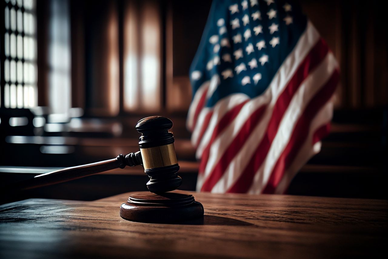 Mallet of judge in American courtroom. American flag in courtroom.