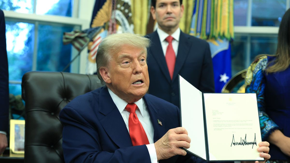 WASHINGTON, DC - JUNE 27: U.S. President Donald Trump sigs a letter of congratulations as he meets with Minister of Foreign Affairs and Cooperation of Rwanda Olivier Nduhungirehe and the Foreign Minister of the Democratic Republic of the Congo Thérèse Kayikwamba Wagner in the Oval Office at the White House on June 27, 2025. The meeting took place as a peace agreement brokered by the White House, which hopes to end a conflict in eastern Democratic Republic of Congo, was signed by officials of the two African nations.  (Photo by Joe Raedle/Getty Images)