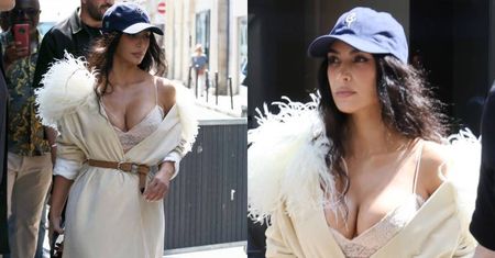 Rozchełstana Kim Kardashian w beżowym szlafroku wymyka się z paryskiego hotelu