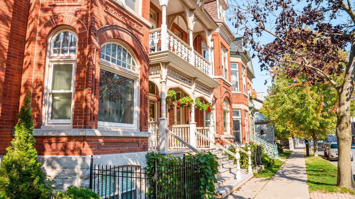 Traditional red brick residential buildings with stairs leading up to the front doors along a tree lined street in a city centre on a sunny autumn day
Banister, Canada, Exterior, Kingston, Lawn, Ontario, Ownership, Property, Row house, Terraced house, Townhouse, architecture, autumn, bay window, brick, building, business, car, city centre, door, downtown, fall, flower, grass, heritage, historic, house, nature, october, old, pavement, people, railing, real estate, renovated, rental, residential, residential building, residential district, sidewalk, sky, staircase, steps, strairs, street, sunlight, sunny, traditional, travel, tree, window