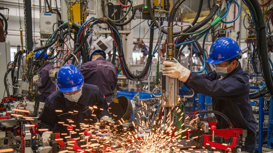 JINHUA, CHINA - OCTOBER 29: Employees work on the assembly line of C01 electric sedan at a factory of Chinese EV startup Leapmotor on October 29, 2022 in Jinhua, Zhejiang Province of China. (Photo by Hu Xiaofei/VCG via Getty Images)