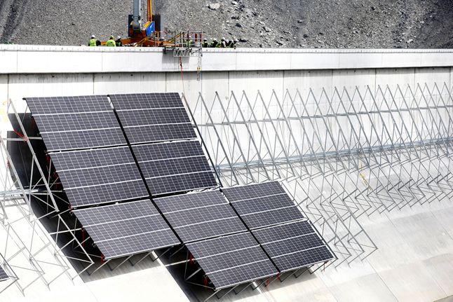 Na górze tamy Muttsee widać maszyny budujące elektrownię SolarAlpine.