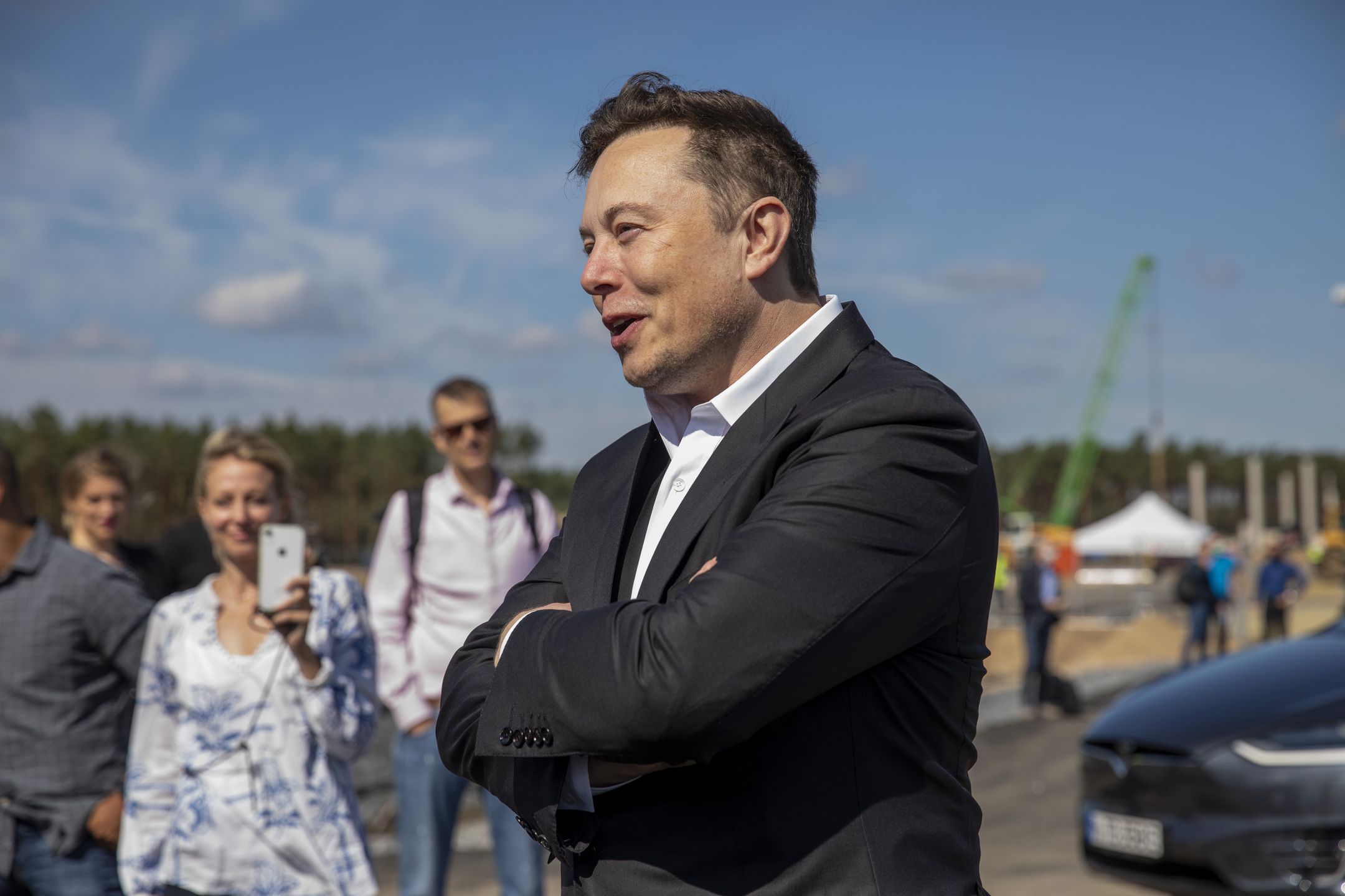 FUERSTENWALDE, GERMANY - SEPTEMBER 03: Tesla head Elon Musk talks to the press as he arrives to to have a look at the construction site of the new Tesla Gigafactory near Berlin on September 03, 2020 near Gruenheide, Germany. Musk is currently in Germany where he met with vaccine maker CureVac on Tuesday, with which Tesla has a cooperation to build devices for producing RNA vaccines, as well as German Economy Minister Peter Altmaier yesterday. (Photo by Maja Hitij/Getty Images)
