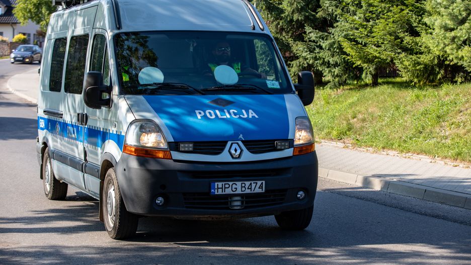 Police car on patrol with the police sign on car hood
