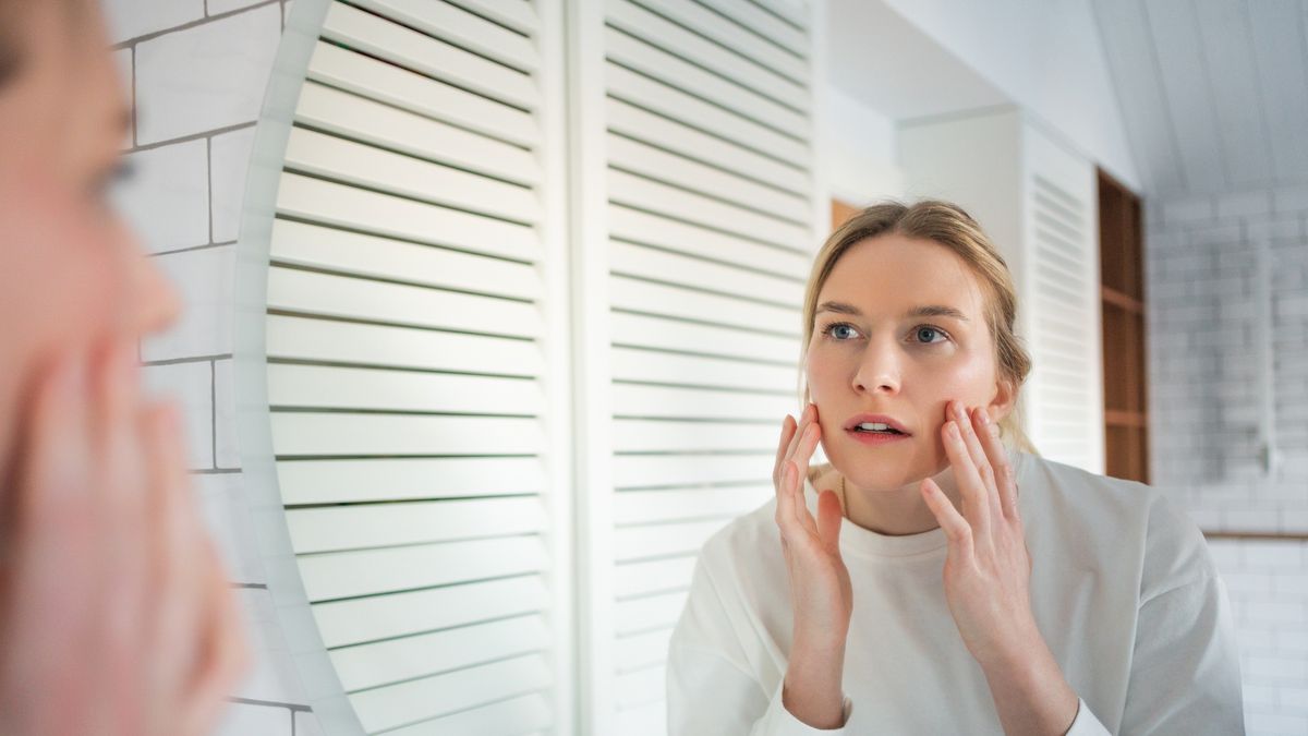 Skin analysis in mirror. Focused woman examines her face for signs of aging and wrinkles in bathroom
Skin concern analysis. Woman examines her face closely in mirror, focusing on aging and skin issues
Tatiana Meteleva