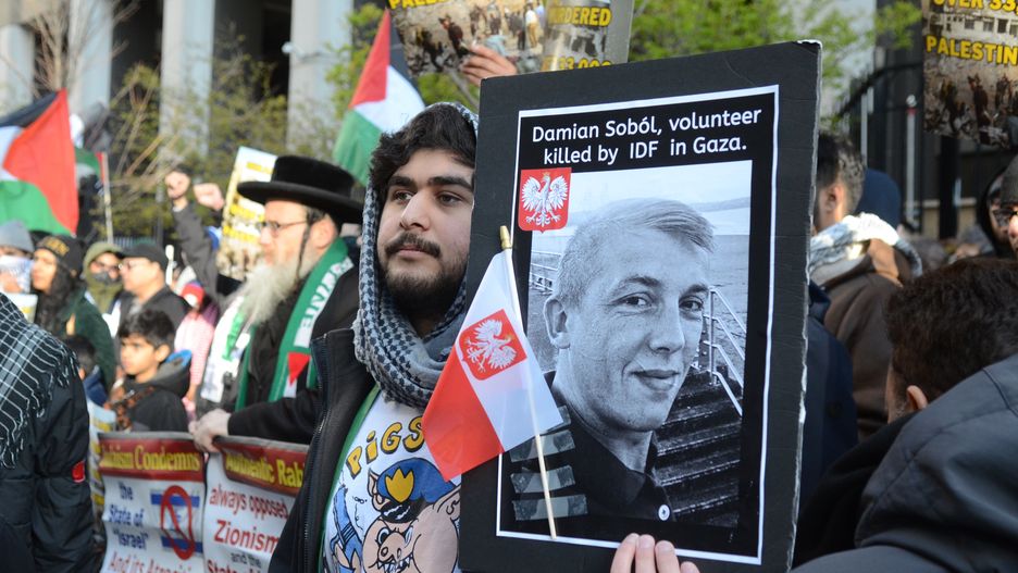 CHICAGO, ILLINOIS - APRIL 5: A protester holds a photo of Damian Sobol from World Central Kitchen during a pro-Palestinian protest outside the Israeli consulate in Chicago, Illinois, United States on April 5, 2024. Damian Sobol was a Polish volunteer who was killed during a humanitarian mission in Gaza on April 1, 2024. (Photo by Jacek Boczarski/Anadolu via Getty Images)