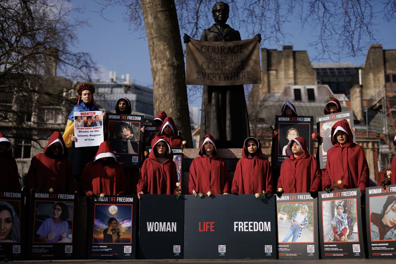 LONDON, ENGLAND - MARCH 8: Protesters dressed as handmaids from The Handmaid's Tale prepare for a march from Parliament Square to Iran's embassy to highlight repression of women in that country on March 8, 2024 in London, England. On March 8th International Women's Day celebrates the social, economic, cultural and political achievements of women globally and highlights the work still to be done to prevent endemic violence against women and inequality. (Photo by Dan Kitwood/Getty Images)