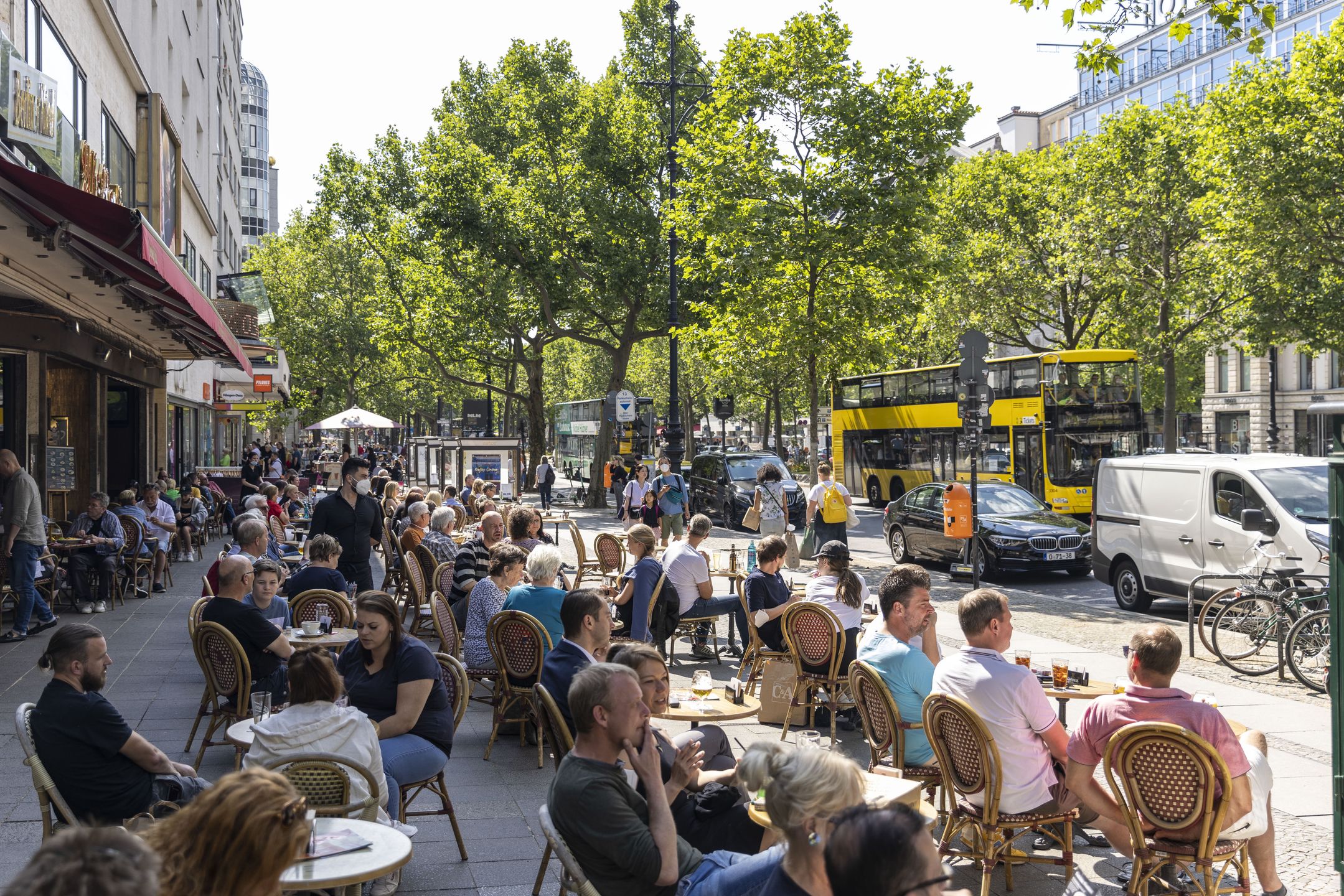 BERLIN, GERMANY - JULY 03: People sit at the restaurant near the popular shopping street Kurfürstendamm on July 03, 2021 in Berlin, Germany. Tourism is showing strong signs of rebound in Berlin as coronavirus infection  rates in Germany and other countries across Europe continue to fall and vaccinations climb. Germany recently removed 80 countries from its pandemic warning roster, making travel to and from those countries easier. The seven-day infection rate in Germany has fallen to 4.9 per 100,000 while approximately 56% of the population has received a first vaccine dose and approximately 38% is fully vaccinated. (Photo by Maja Hitij/Getty Images)