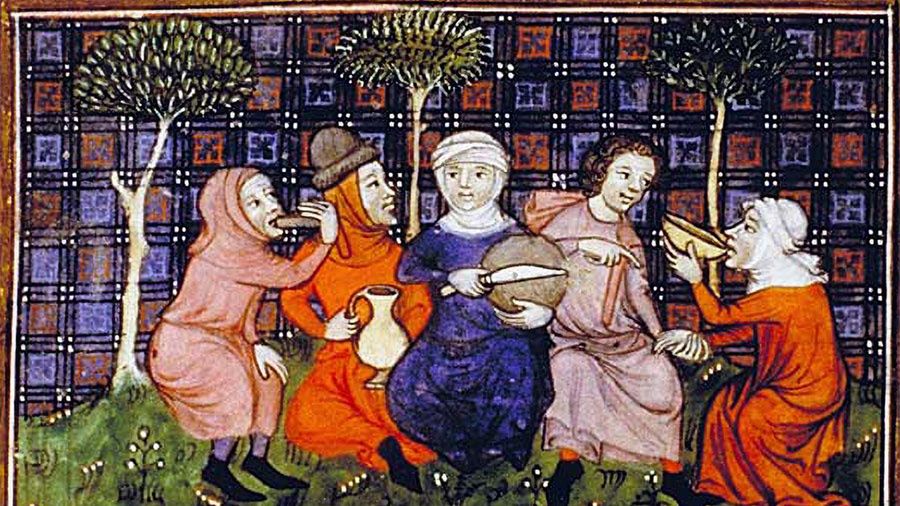 Średniowieczni chłopi przy posiłku.