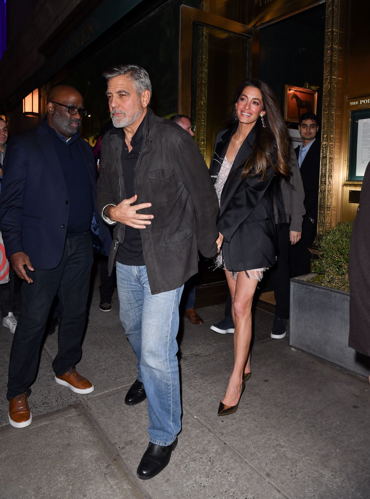 NEW YORK, NEW YORK - DECEMBER 14: George Clooney and Amal Clooney leave the Polo Bar on December 14, 2023 in New York City. (Photo by James Devaney/GC Images)