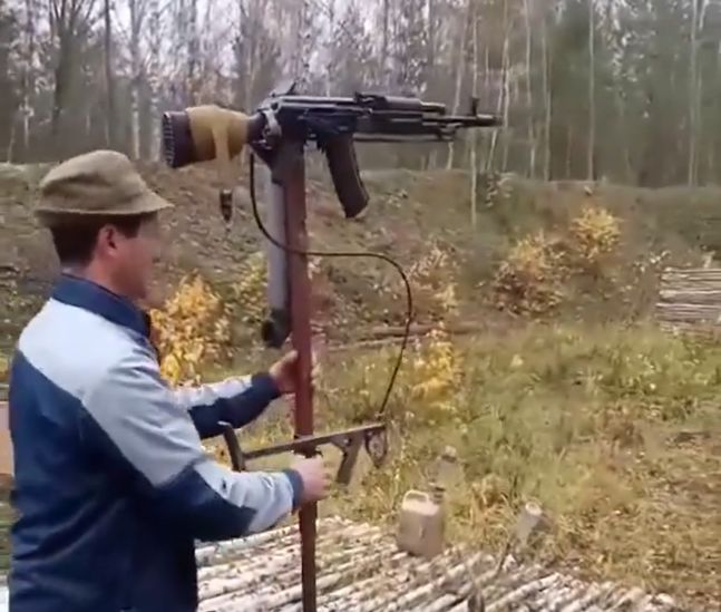 A Ukrainian soldier testing a periscopic sight paired with an AK rifle.