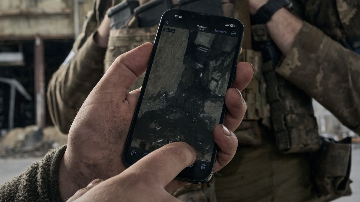 KOSTIANTYNIVKA, UKRAINE - JUNE 16: Soldiers who have left their positions show photos on their phones of what their dugout looks like after the rain during military operations in the city on June 16, 2025 in Kostiantynivka, Ukraine. Russian forces have recently increased offensive activity as they attempt to capture Kostiantynivka in the Donetsk region of Ukraine, advancing on the town from three sides.(Photo by Kostiantyn Liberov/Libkos/Getty Images)