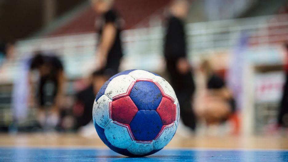 Handball ball on court' s floor. Ready for the match. Blurred referees, coaches and athletes and field background.handball, ball, sport, court, floor, match, team, goal, closeup, athletes, referees, coaches, field, play, athletic, recreation, competition, trainer, championship, exercise, indoor,  lifestyle, game, success, leisure, power, people, energy, active, action, dynamic, recreational, practice, physical, moving, attack, aggression, high, shoot, hit, throw, cup, final, background, blurred, dirty, group, league, aim, player,, handball, ball, sport, court, floor, match, team, goal, closeup, athletes, referees, coaches, field, play, athletic, recreation, competition, trainer, championship, exercise, indoor, lifestyle, game, success, leisure, power, people, energy, active, action, dynamic, recreational, practice, physical, moving, attack, aggression, high, shoot, hit, throw, cup, final, background, blurred, dirty, group, league, aim, player