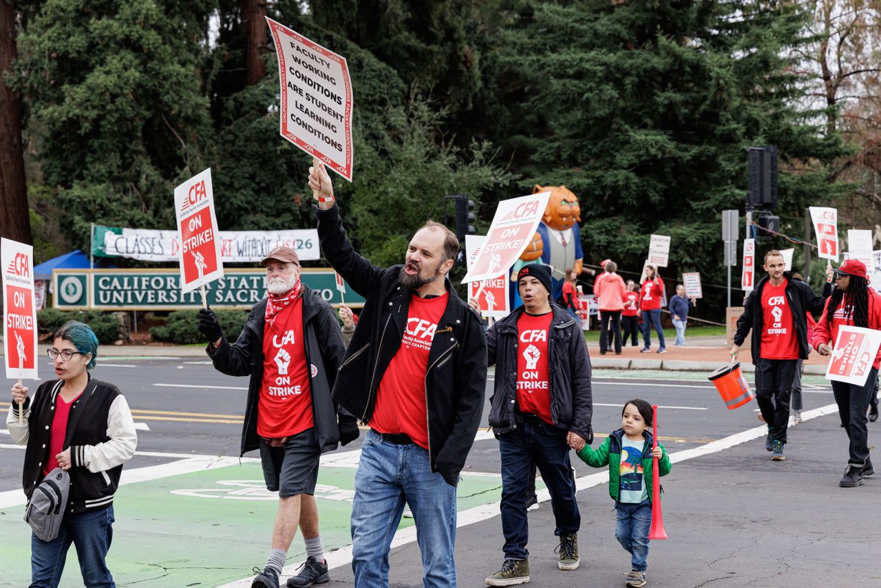 Members of the California Faculty Association (CFA) union are striking at the corners of J Street and State University Drive at California State University - Sacramento, in Sacramento, California, on January 22, 2024. The union, which represents over 29,000 faculty members across 23 campuses in the California State University system, is anticipating a week-long strike aimed at improving salaries, working conditions, and learning facilities. (Photo by Penny Collins/NurPhoto via Getty Images)