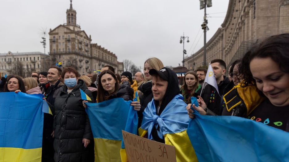 Ukraine Marks Newly Created Unity Day Amid Invasion TensionKYIV, UKRAINE - FEBRUARY 16: People gather to sing the Ukrainian national anthem in front of Independence monument  to mark newly created "Unity Day" on February  16, 2022, in Kyiv, Ukraine.  "Unity Day" was created by Ukraine's president this week, in response to news reports that February 16 would be the date Russian forces invade Ukraine after Russian forces have been massing on the Ukrainian border over the past months.  (Photo by Chris McGrath/Getty Images)Chris McGrath