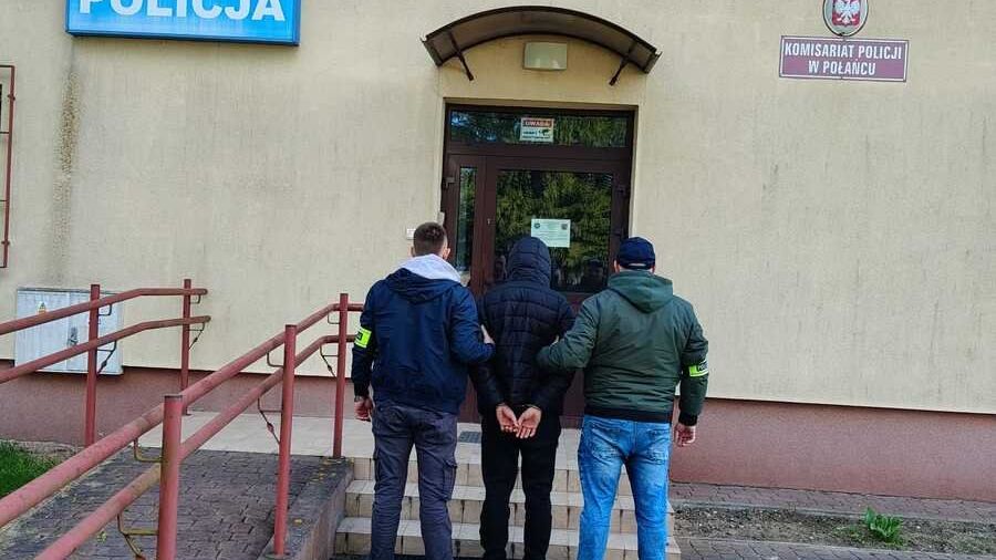 Zatrzymany mężczyzna w asyście funkcjonariuszy