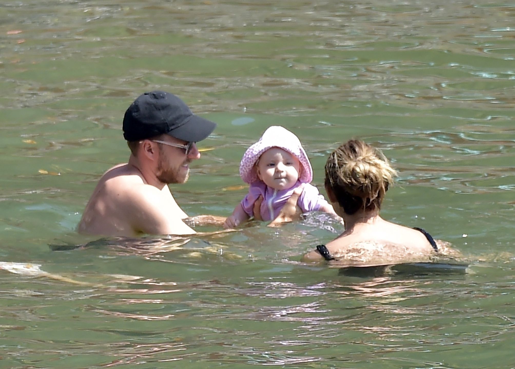 *EXCLUSIVE* Danish footballer Christian Eriksen with his wife Sabrina Kvist Jensen and their children on vacation in Portofinoportofino, ITALY  - *EXCLUSIVE*  - Danish footballer Christian Eriksen who suffered a cardiac arrest while playing for Denmark at Euro 2020 seems to have made a full recovery as he is seen with his wife Sabrina Kvist Jensen and their children enjoying a beach day in Portofino.BACKGRID UK 15 AUGUST 2021,Image: 627240007, License: Rights-managed, Restrictions: RIGHTS: WORLDWIDE EXCEPT IN ITALY, Model Release: no, Credit line: Cobra Team / BACKGRID / Backgrid UK / ForumCobra Team / BACKGRID / Backgrid UK / ForumChristian Eriksen, Black Cap, Nike, Brand, Facial Hair, Beard, Black Sunglasses, Shirtless, Bare Chest, Bare Chested, Sabrina Kvist Jensen, Holding, Carrying, Baby, Cute, Football Player, Footballer, Holiday, Vacation, Enjoy, Enjoying, Couple, Partner, Dip