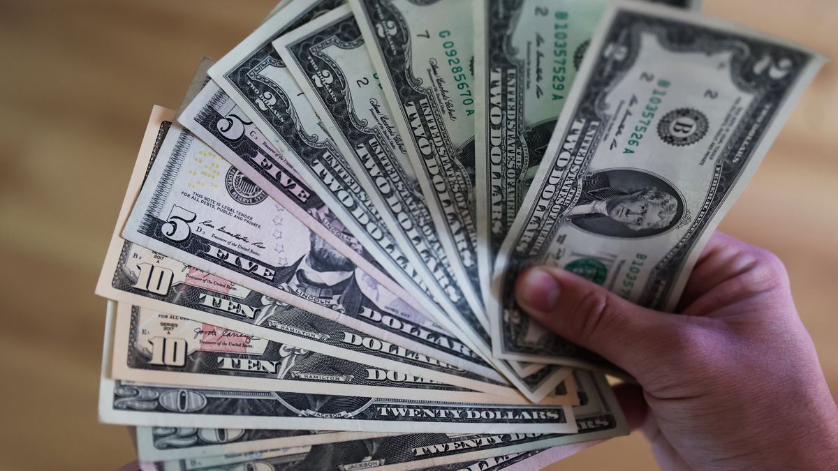 A person holds United States dollar banknotes  in this illustration photo taken in Poland on December 26, 2022. (Photo by Jakub Porzycki/NurPhoto via Getty Images)