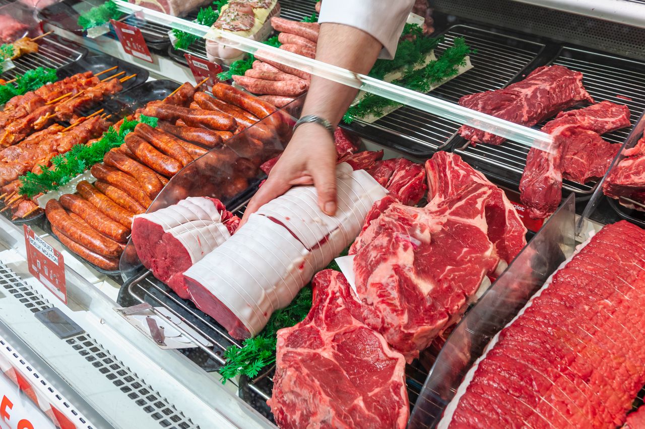 Butcher's in a supermarket. Butcher's taking a roast beef, meat for sale in a butcher's shop window. (Photo by: Leitenberger S/Andia/Universal Images Group via Getty Images)