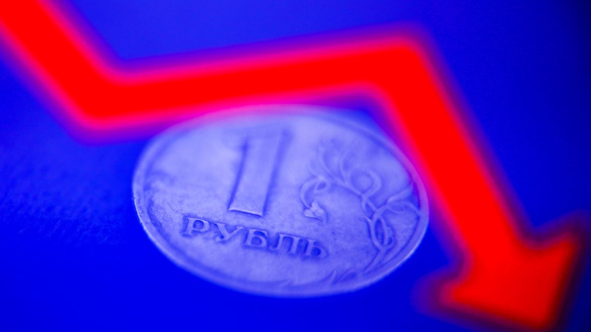 Russian one ruble coin and an illustrative graph displayed on a screen are seen in this multiple exposure illustration photo taken in Krakow, Poland on March 8, 2022. (Photo illustration by Jakub Porzycki/NurPhoto via Getty Images)