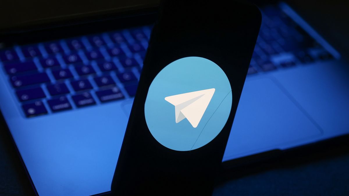 Telegram logo displayed on a phone screen and a laptop are seen in this illustration photo taken in Krakow, Poland on November 27, 2022. (Photo by Jakub Porzycki/NurPhoto via Getty Images)