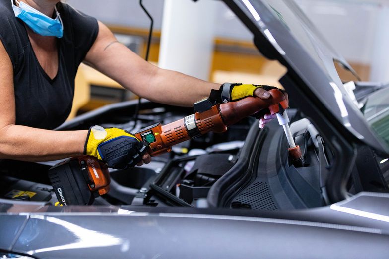 An employee fixes a fastener under the hood of a Volkswagen AG (VW) ID.5 electric sports utility vehicle (eSUV) on the assembly line at the automaker's electric automobile plant in Zwickau, Germany, on Tuesday, April 26, 2022. The Zwickau assembly lines are the centerpiece of a plan by VW, the world's biggest automaker, to manufacture as many as 330,000 cars annually. Photographer: Krisztian Bocsi/Bloomberg via Getty Images