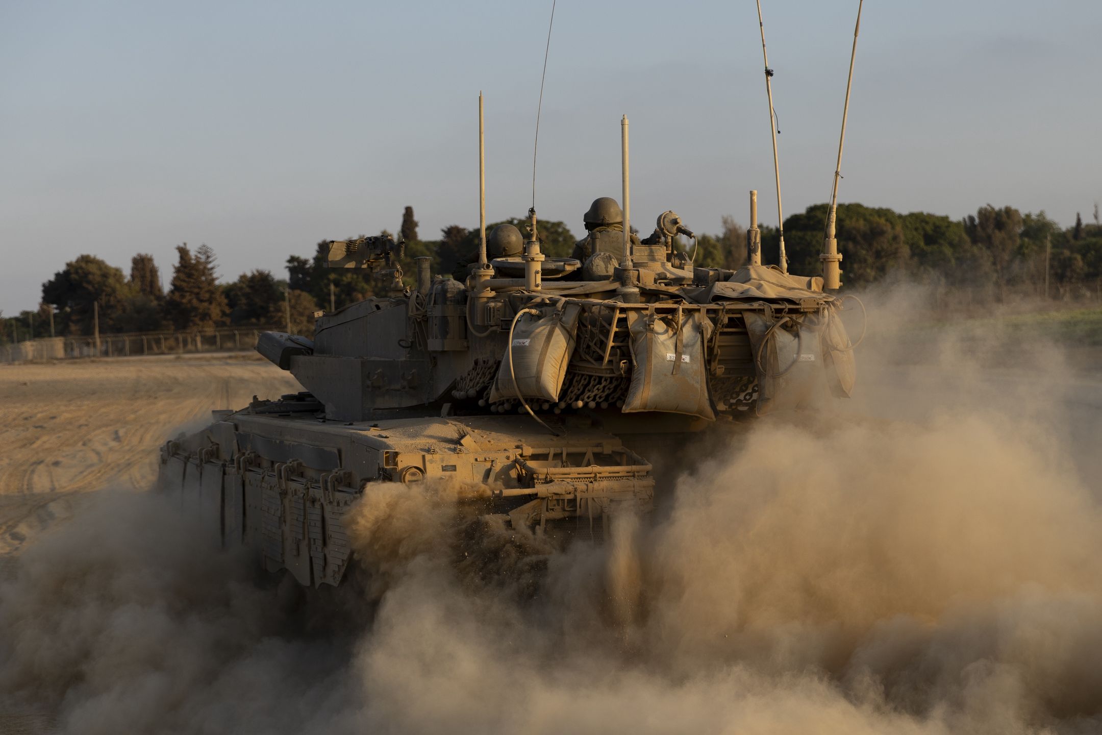 SOUTHERN ISRAEL, ISRAEL - AUGUST 7: Israeli soldiers in a tank as it drives along the border with the Gaza Strip on August 7, 2024 in Southern Israel, Israel. Ten months has passed since the Oct. 7th Hamas-led attack on southern Israel, which sparked a devastating war in Gaza that threatens to spill into the wider region. (Photo by Amir Levy/Getty Images)