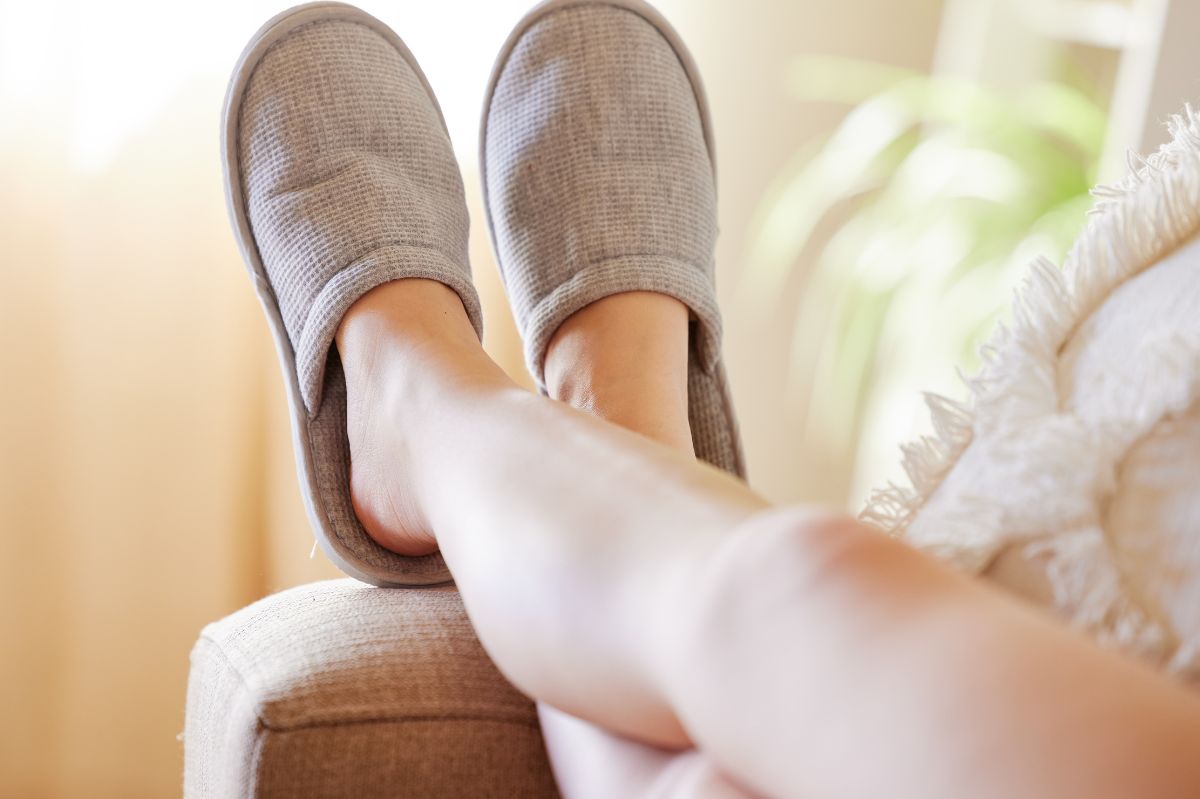 Women's legs in shoes around the house.